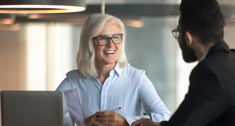 Woman smiling at a man who is facing away from the camera