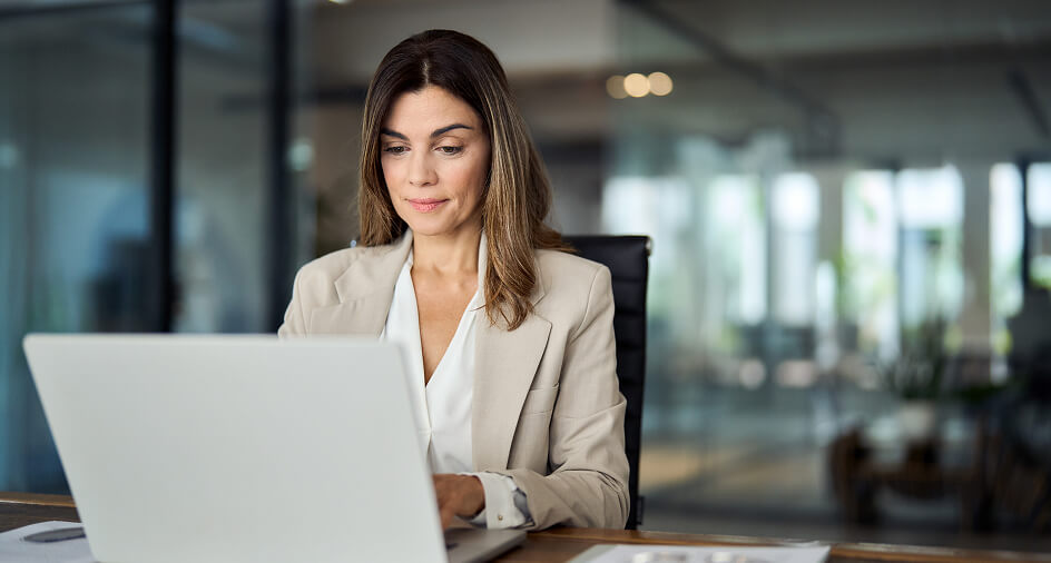 Lady on a laptop in a corporate environment